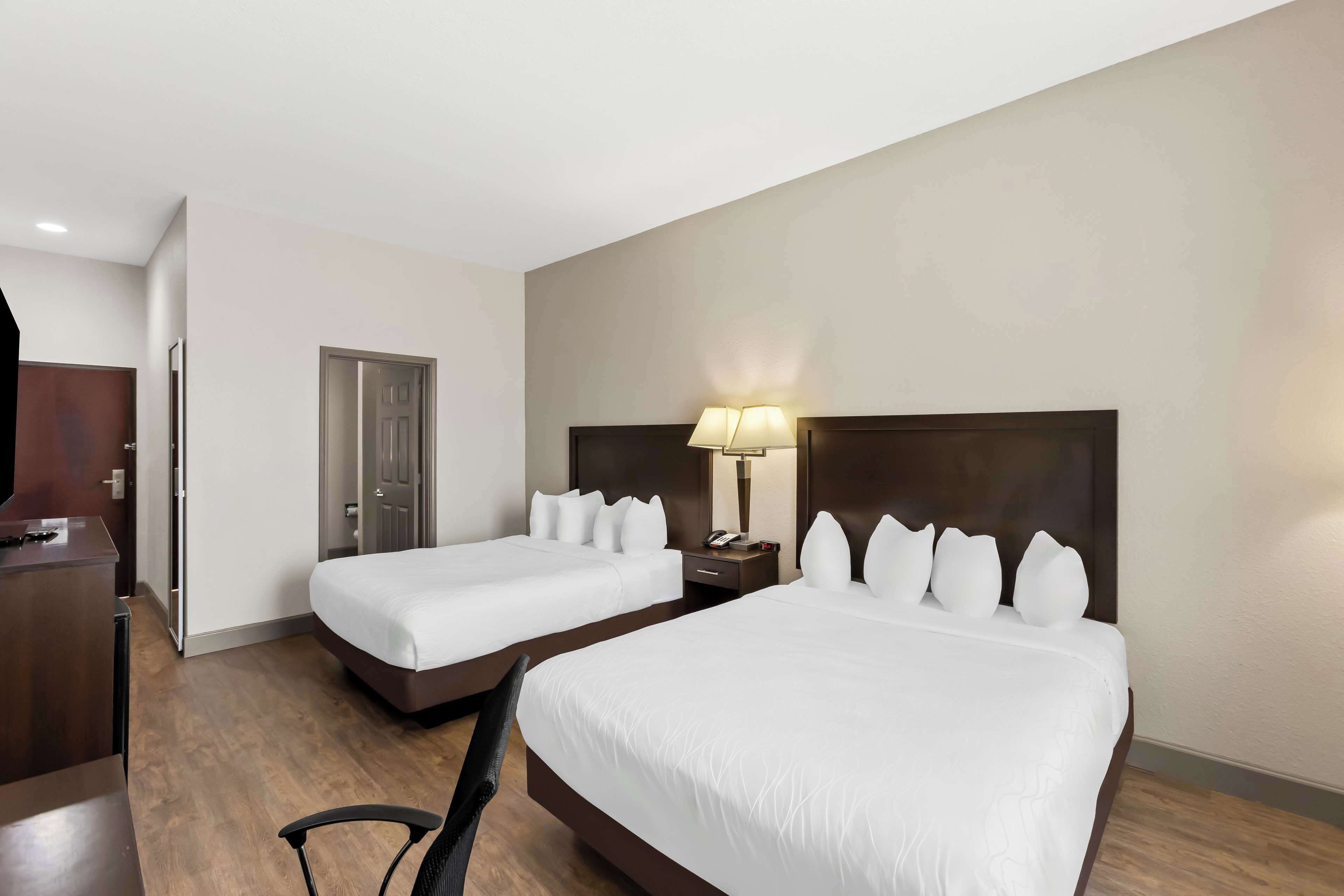 Premium bedding, desk, laptop workspace, blackout drapes