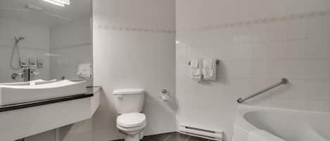 A modern bathroom with a white sink, toilet, and bathtub.