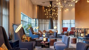 A spacious lobby with modern seating, large windows, and a unique chandelier. - Radisson Blu Hotel, Trondheim Airport (Stjordal)