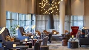 A spacious lobby with modern seating, a unique chandelier, and large windows. - Radisson Blu Hotel, Trondheim Airport (Stjordal)