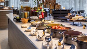 A buffet setup with various food items and serving utensils. - Radisson Blu Hotel, Trondheim Airport (Stjordal)