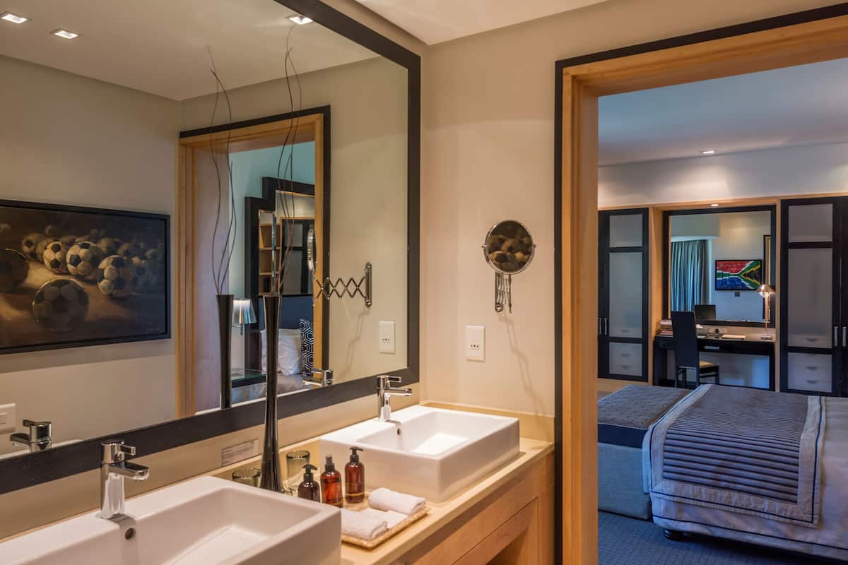 executive suite, 1 king bed | bathroom | separate bathtub and shower, designer toiletries, hair dryer, bathrobes