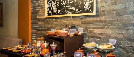 A buffet area with gluten-free options, including various dishes and beverages.