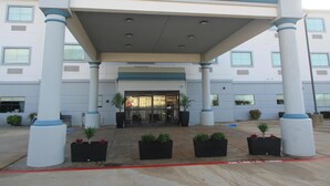 A hotel entrance with a covered walkway, columns, and potted plants. - Best Western Decatur Inn (Decatur)