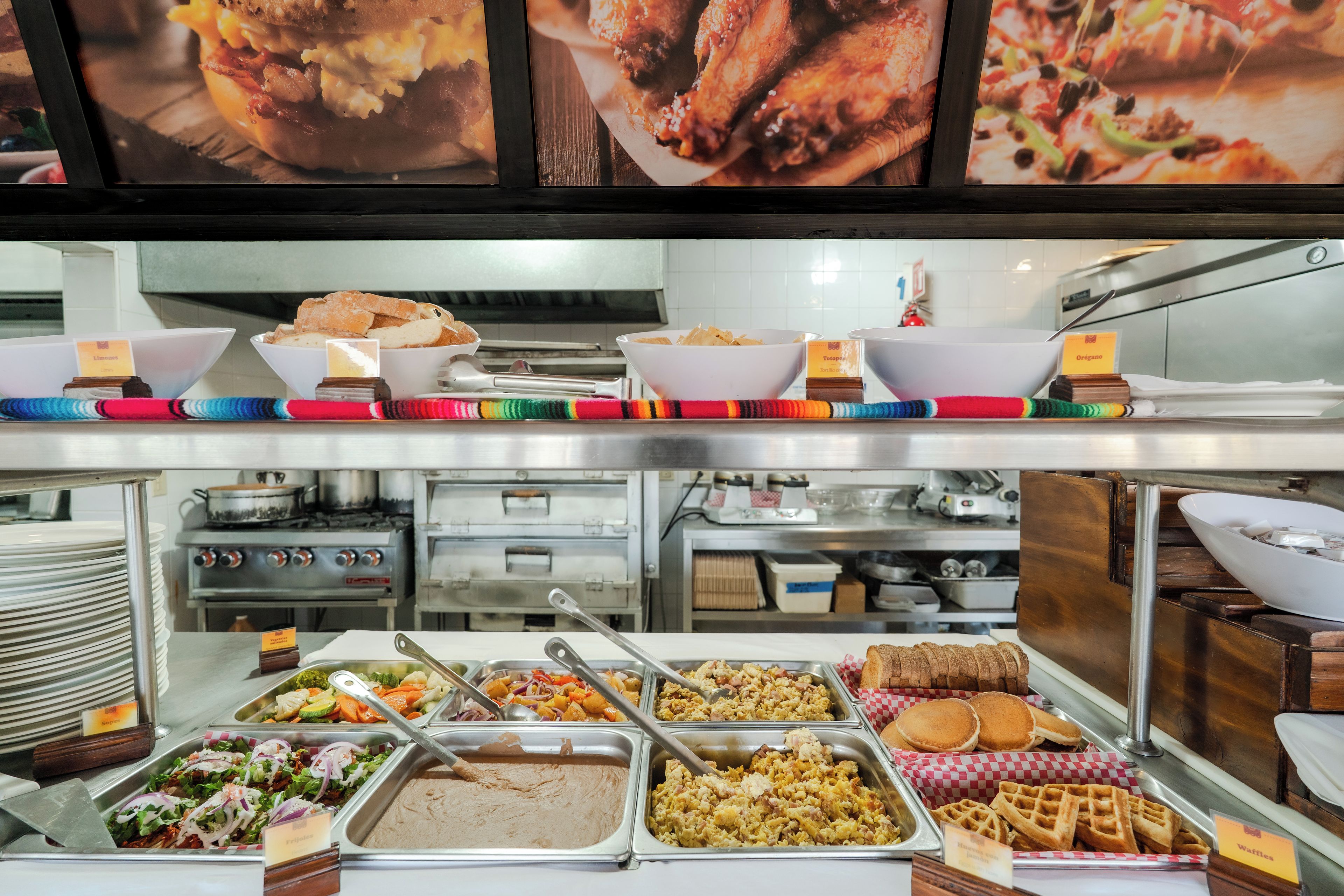 A buffet with various food options including salads, meats, and baked goods.