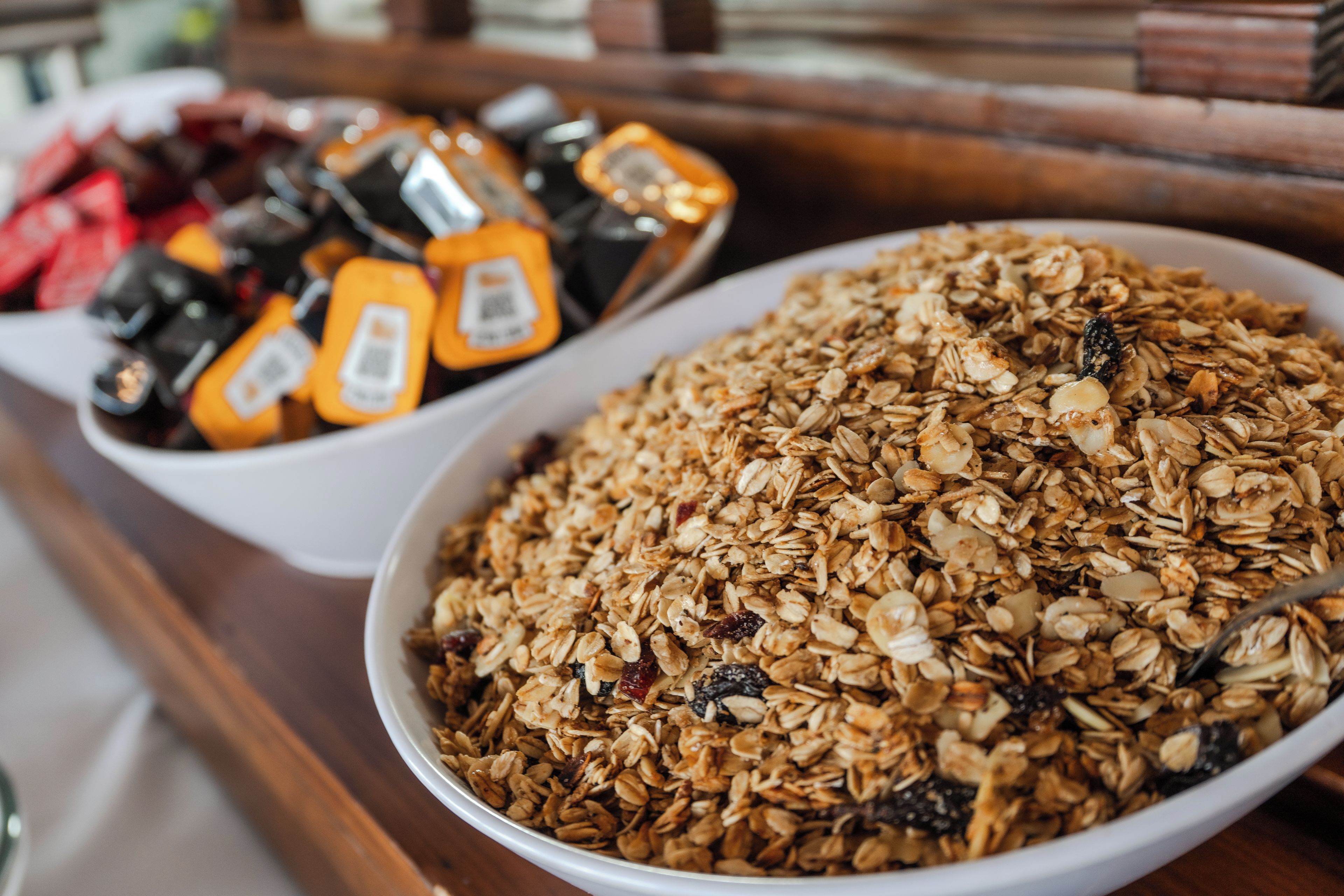 A bowl of granola with nuts and dried fruits.