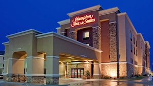 A Hampton Inn & Suites building with a stone facade, large entrance, and a neon sign. - Hampton Inn & Suites Aberdeen (Aberdeen)