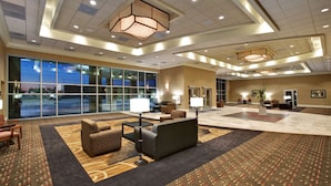 A spacious lobby with a large seating area, a reception desk, and a view of the outdoors through large windows. - Hampton Inn & Suites Aberdeen (Aberdeen)
