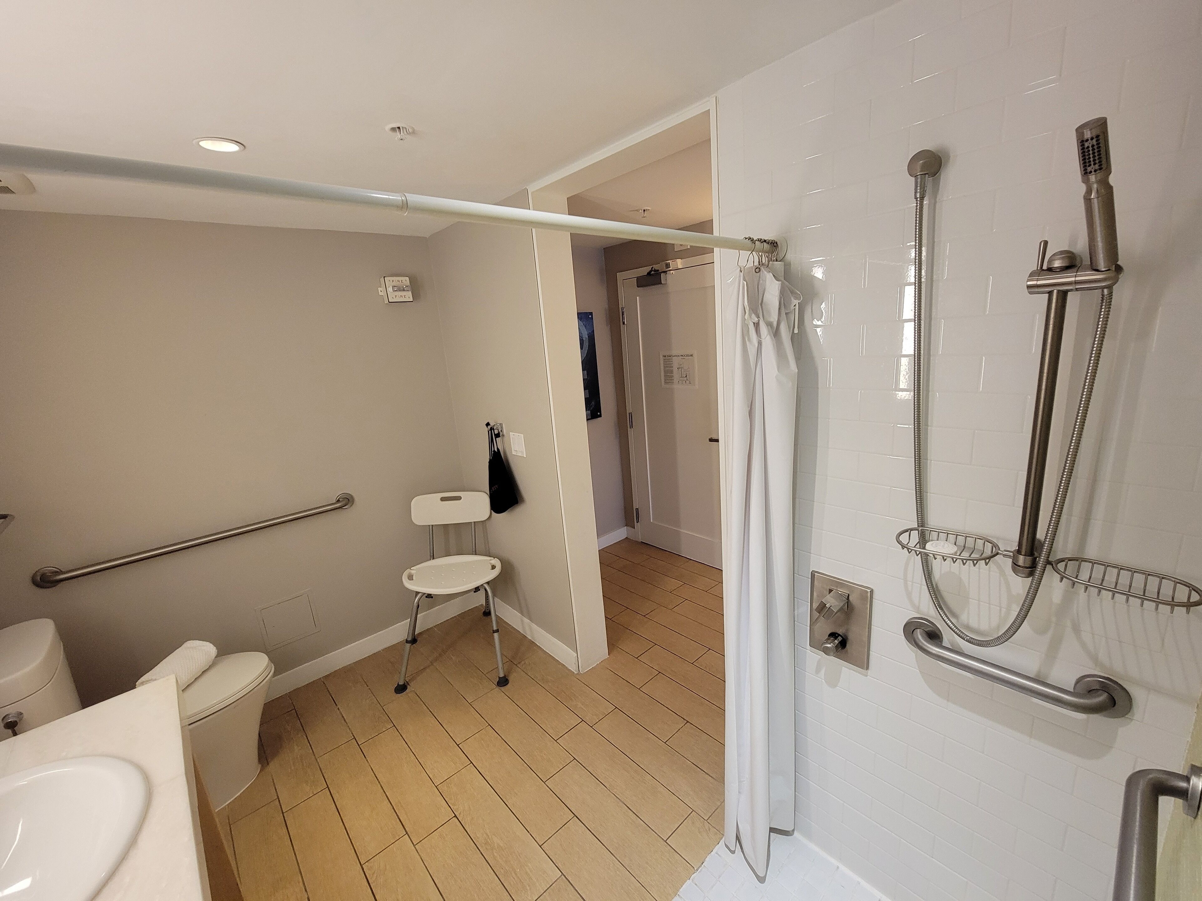 A modern bathroom with a toilet, sink, and shower area.