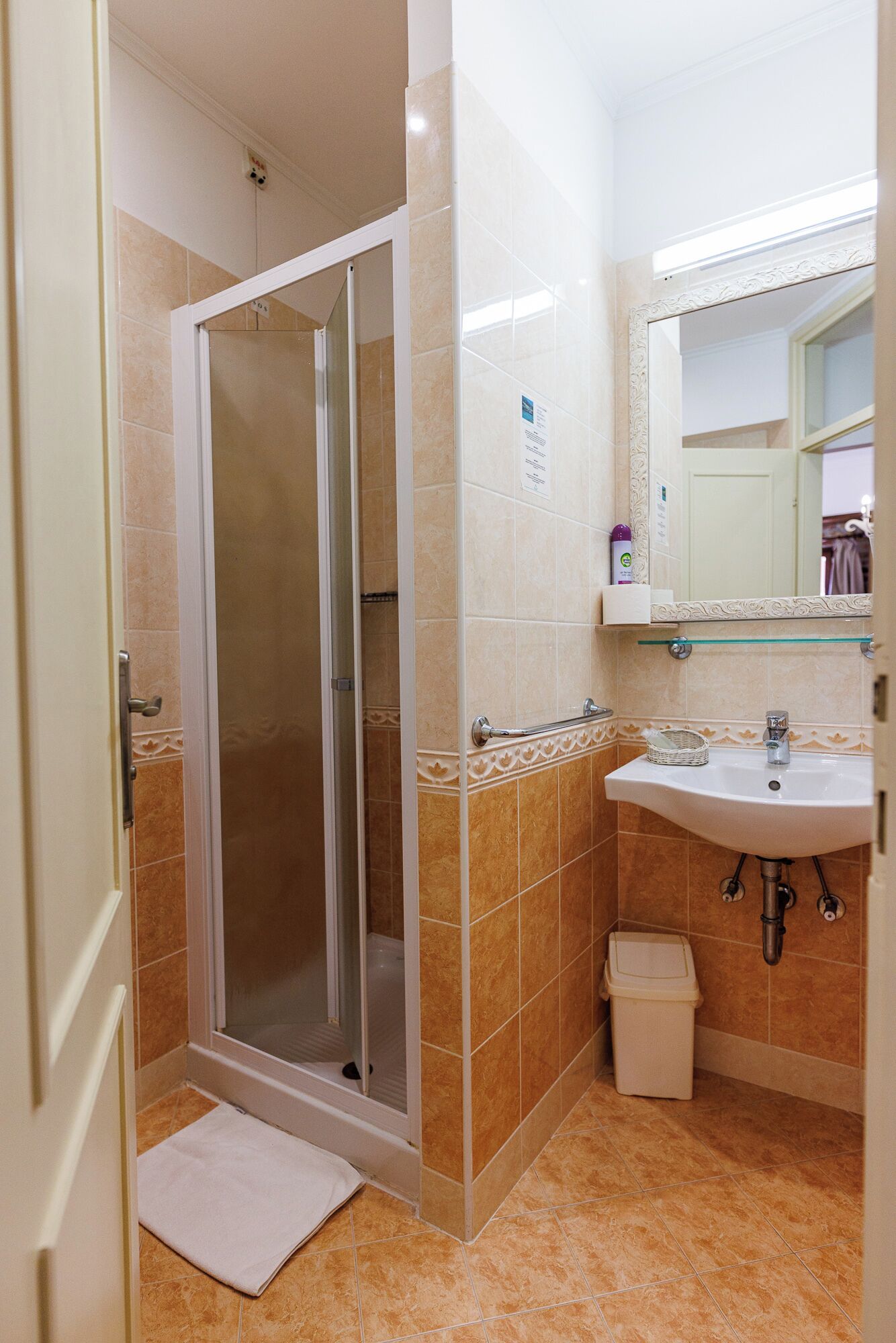 A bathroom with a shower, sink, and toilet.