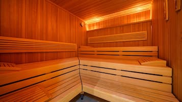 Un sauna avec des bancs en bois et un plafond incliné.