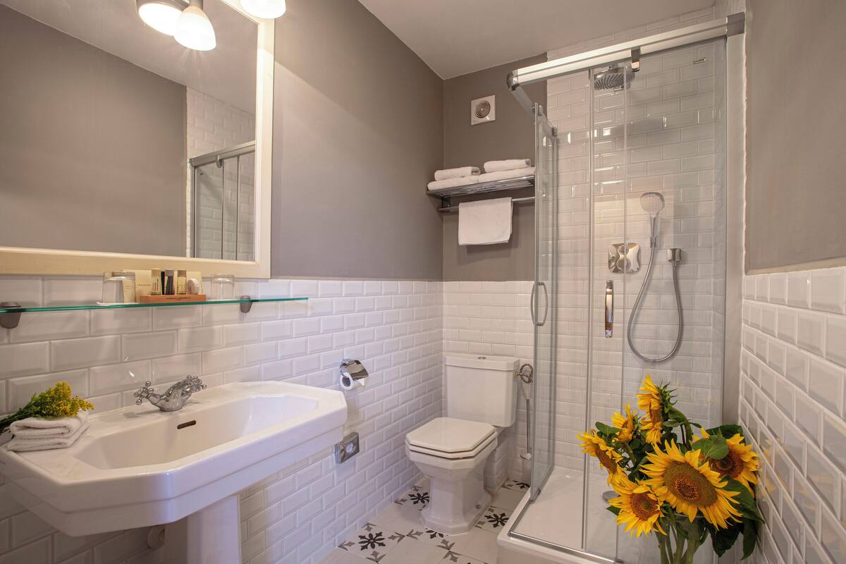 designer toiletries, hair dryer, bathrobes, slippers