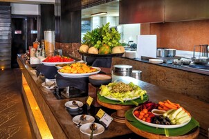 A buffet with various food items and condiments.