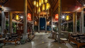 A spacious lobby with high ceilings, ornate columns, and traditional lanterns. - Khum Phaya Resort & Spa Boutique Collection (Chiang Mai)