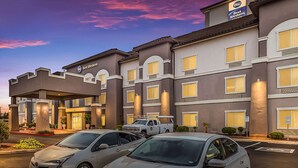 A Best Western hotel with a modern facade, multiple windows, and a parking lot with cars. - Best Western Douglas Inn & Suites (Douglas)