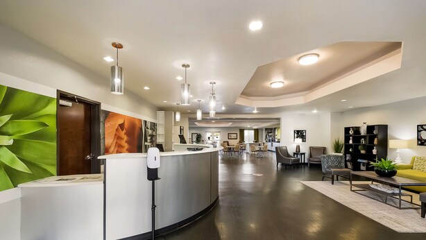 A modern reception area with a curved counter, seating arrangements, and a well-lit interior. - Best Western Douglas Inn & Suites (Douglas)