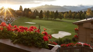 A golf course with a view of mountains in the background.