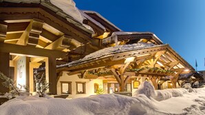 A snow-covered building with wooden beams and a balcony.