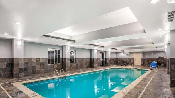 An indoor swimming pool with clear water, surrounded by stone walls and a tiled floor. - La Quinta Inn & Suites by Wyndham Conway (Conway)