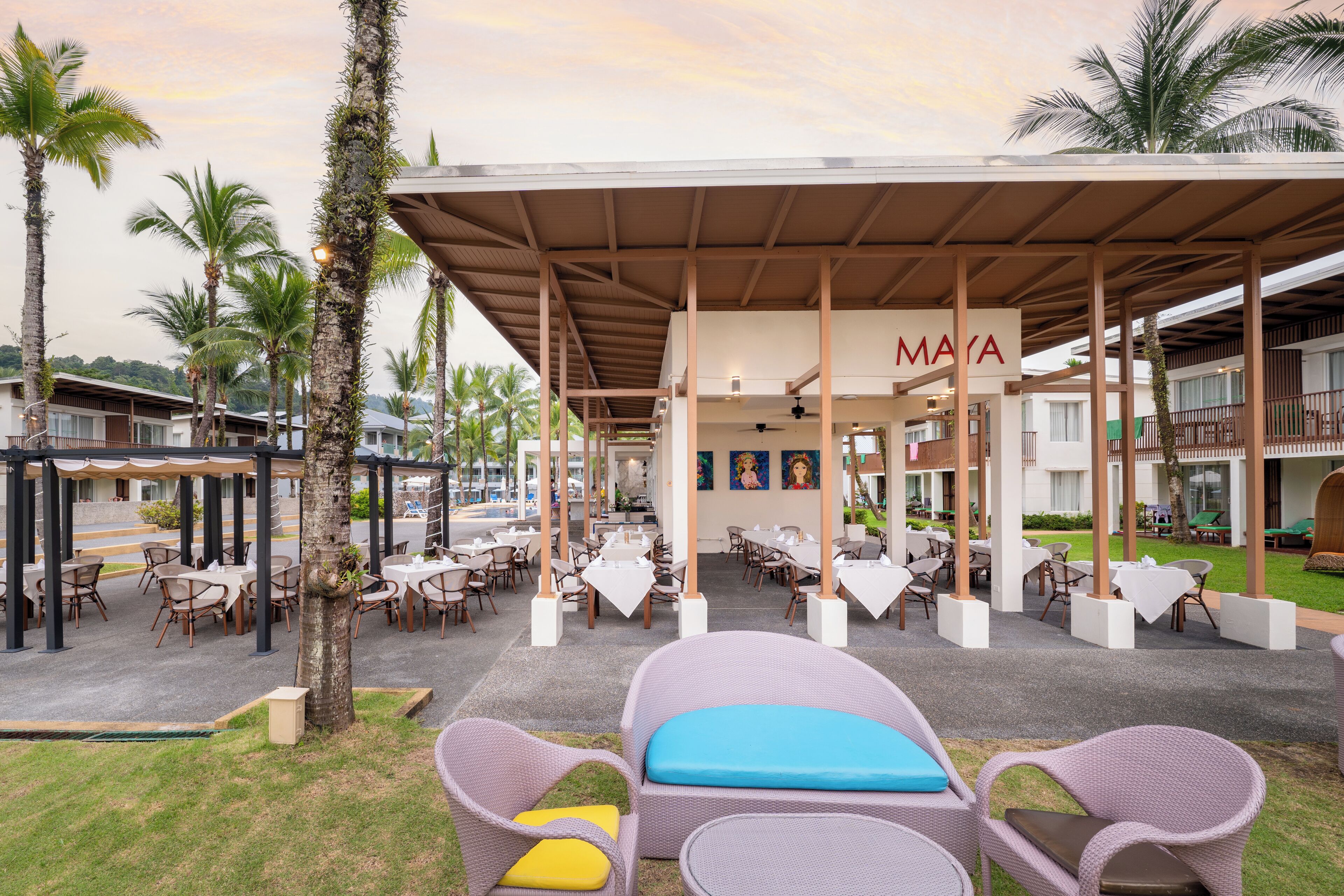 An outdoor seating area with wicker furniture and a covered patio.