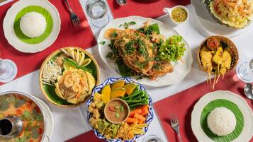 A table with various dishes including rice, fish, and vegetables, suggesting a meal setting.