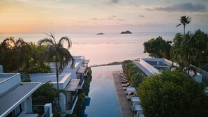 A resort with a pool, lounge chairs, and a view of the sea at sunset. - The Chill Resort & Spa Koh Chang (Ko Chang)