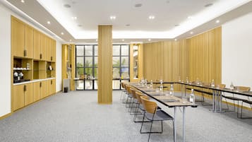 A conference room with a long table, chairs, and a central pillar.