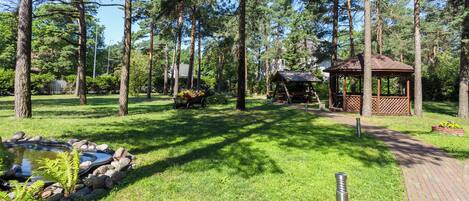 A park with a pond, picnic area, and gazebo.