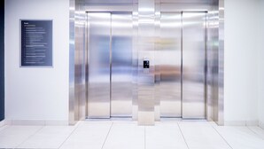 A modern elevator with a control panel and a directory sign on the wall. - Hotel Dzingel (Tallinn)