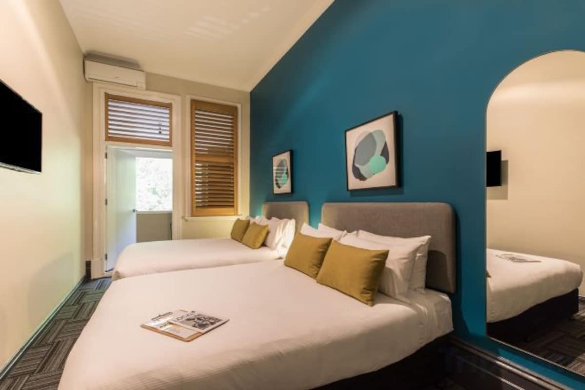 Family Quad Room with Balcony and Shared Bathroom