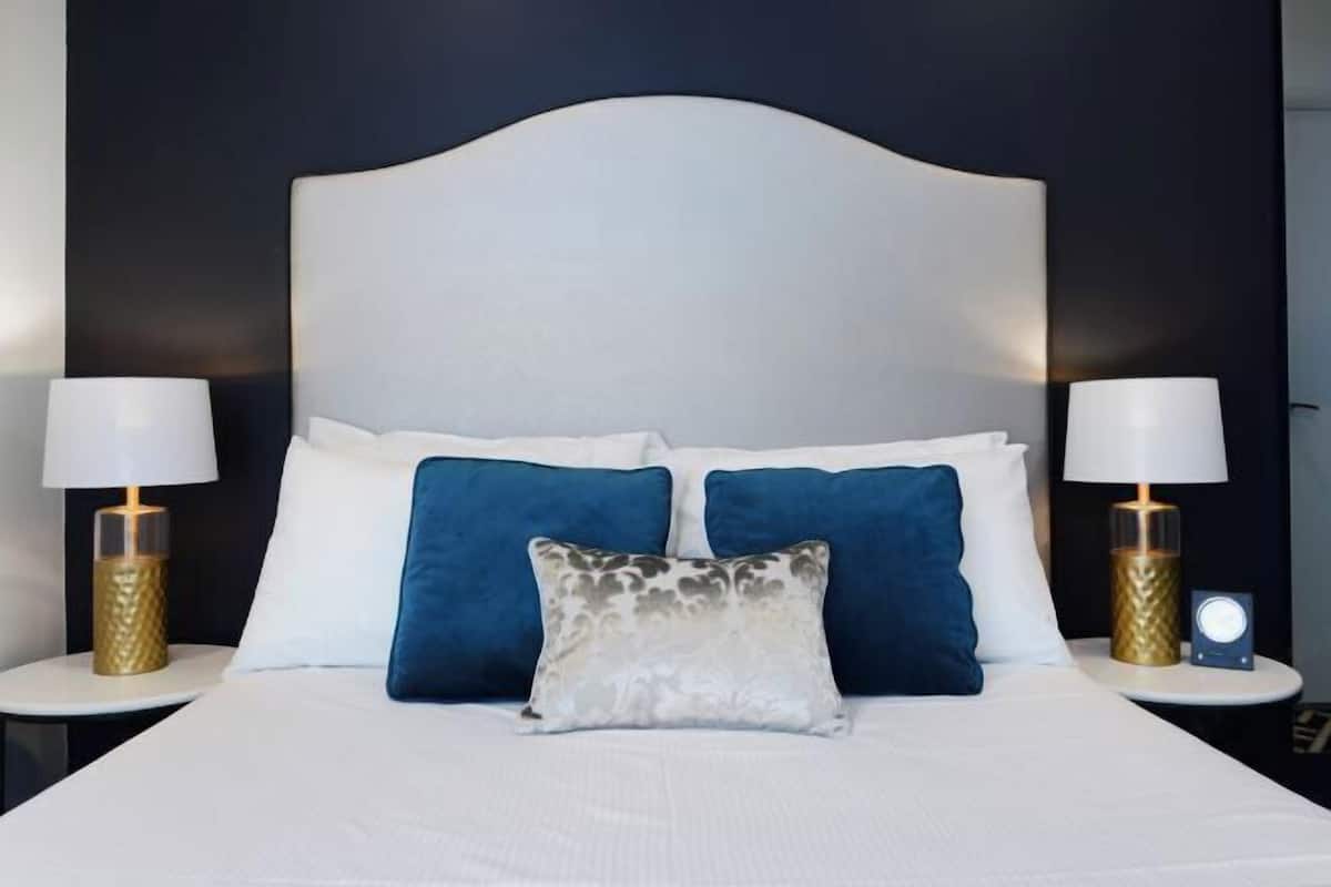 Premium bedding, desk, laptop workspace, blackout drapes