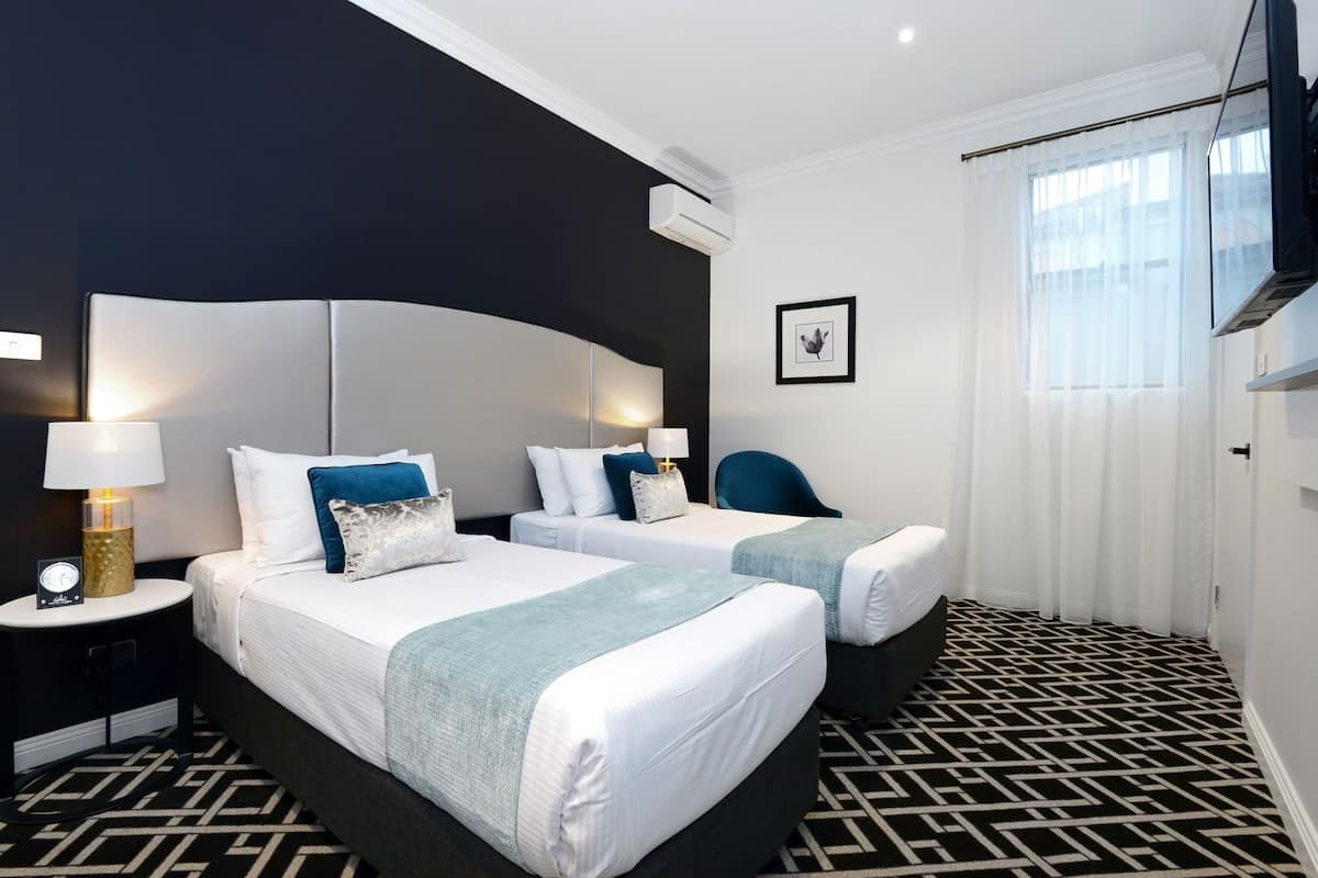 Premium bedding, desk, laptop workspace, blackout drapes