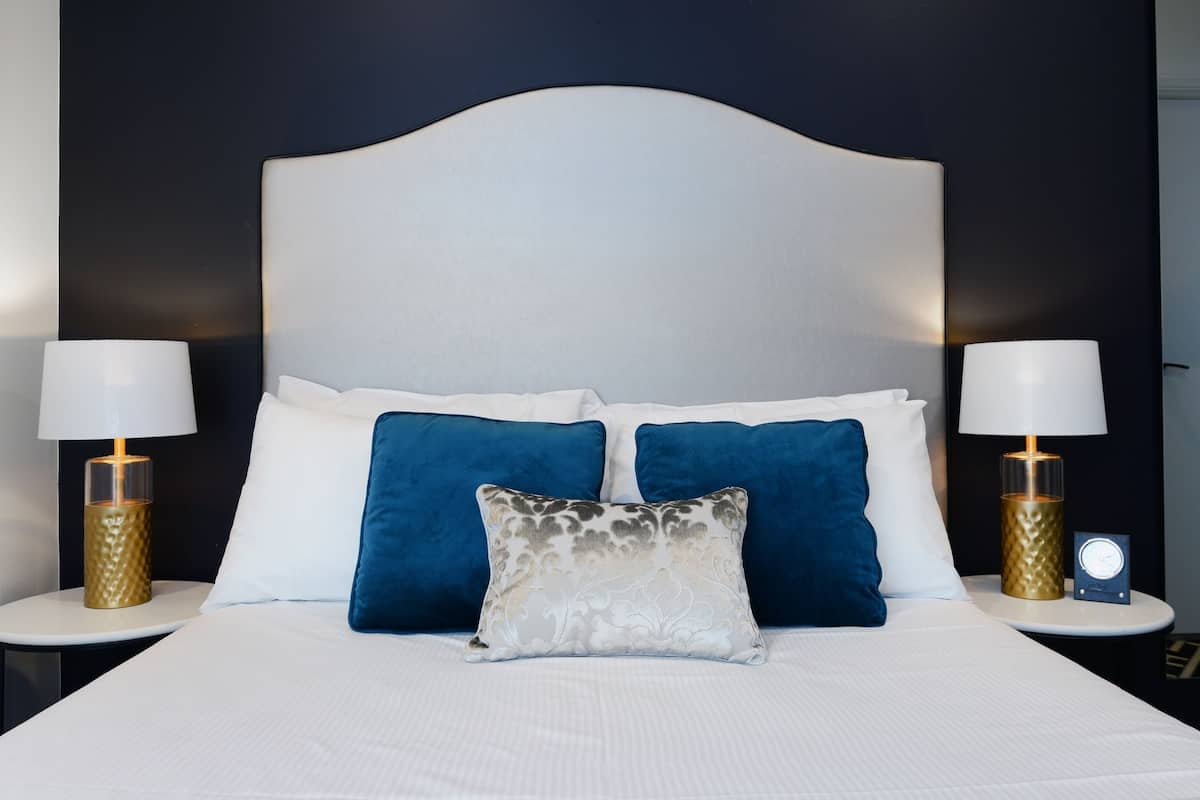 Premium bedding, desk, laptop workspace, blackout drapes