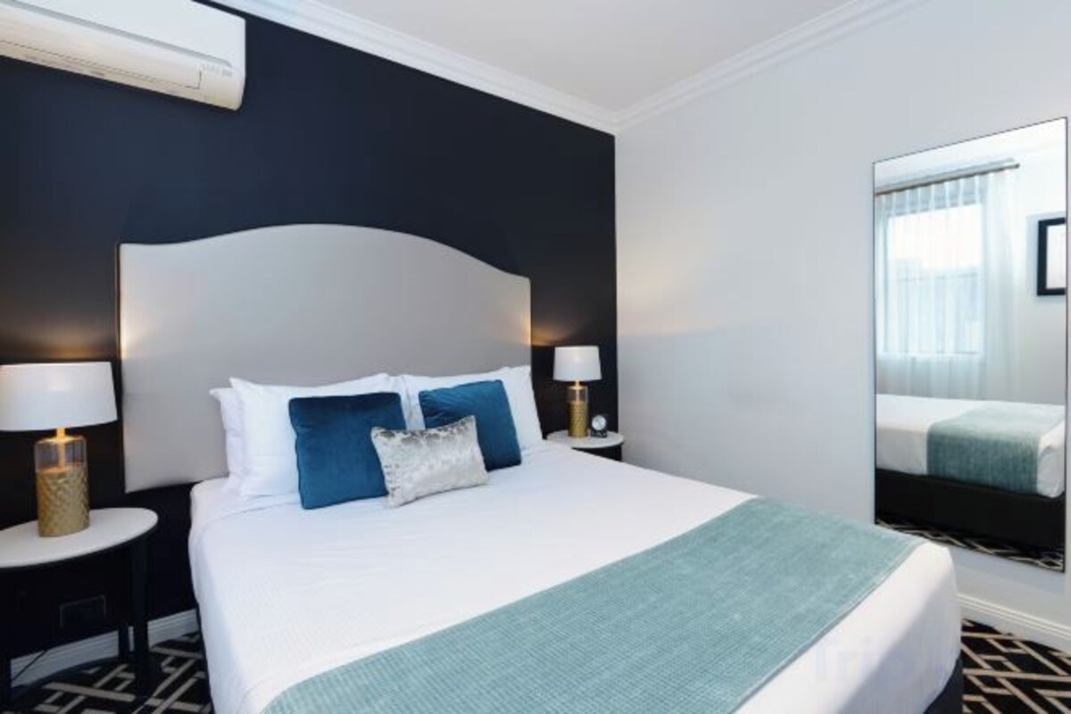 Premium bedding, desk, laptop workspace, blackout drapes