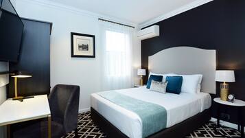 Premium bedding, desk, laptop workspace, blackout drapes