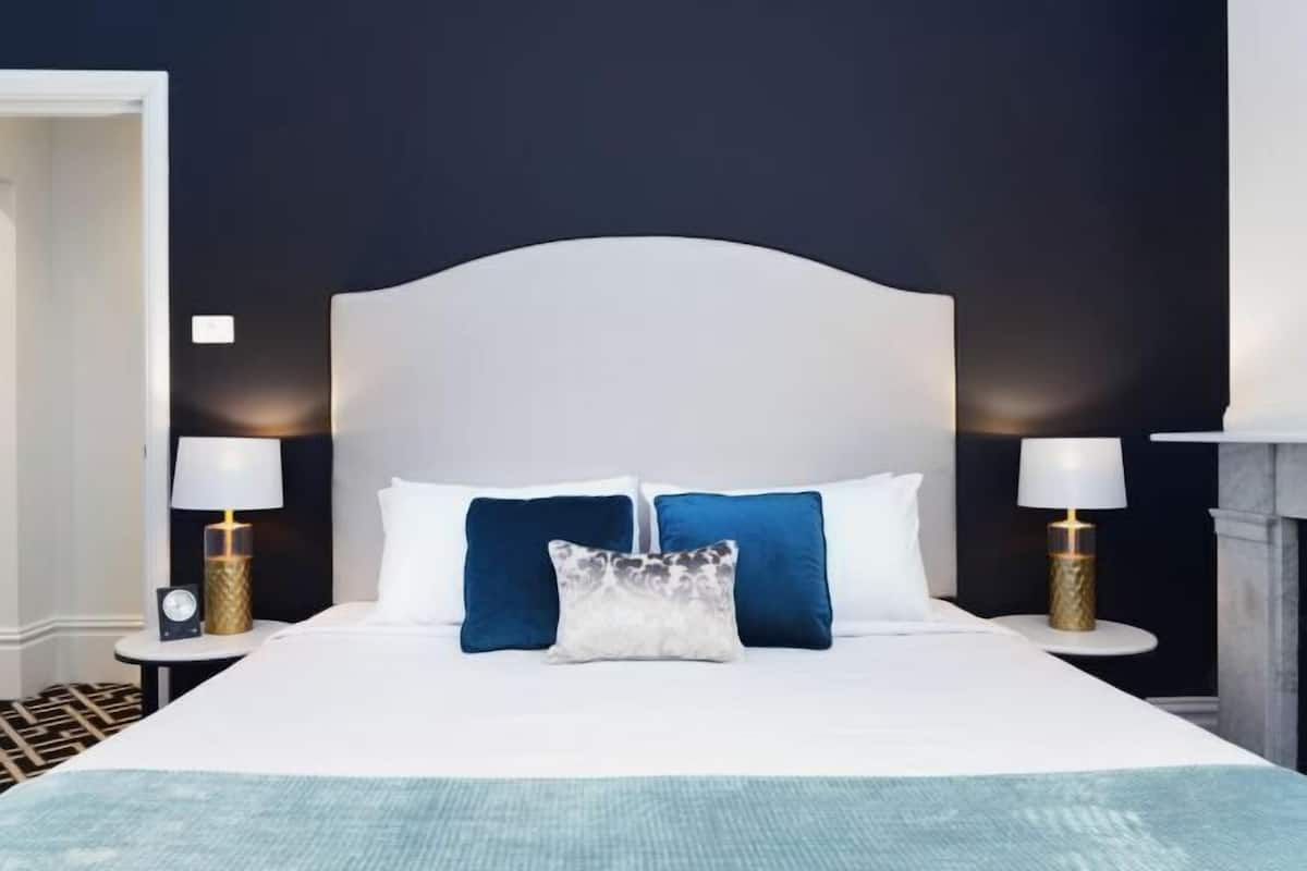 Premium bedding, desk, laptop workspace, blackout drapes