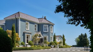 A large, two-story building with a grey facade and white trim, featuring multiple windows and a symmetrical design. - Summerhill House Hotel (Enniskerry)