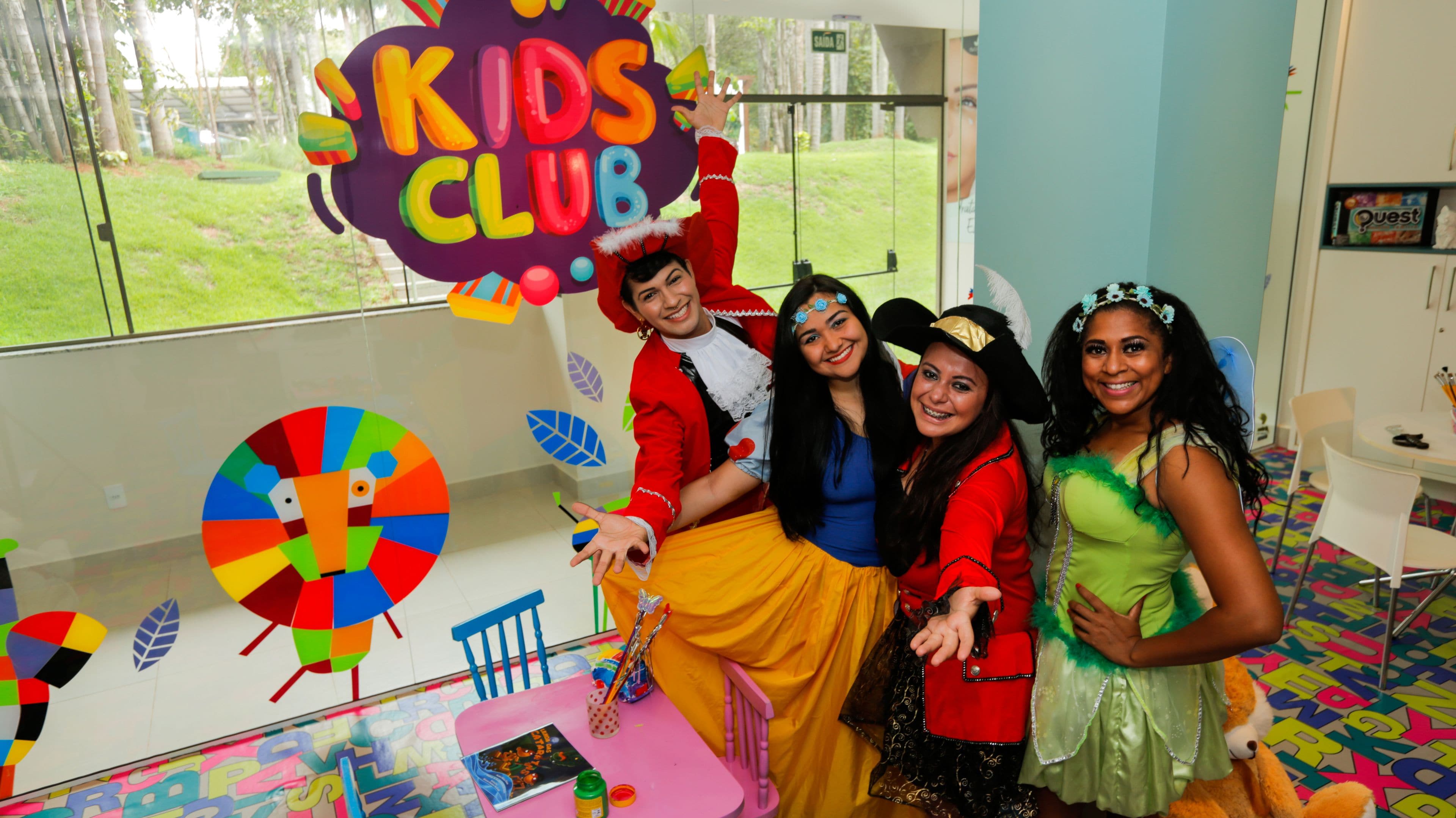 A room with a colorful play area, a large window, and a door.