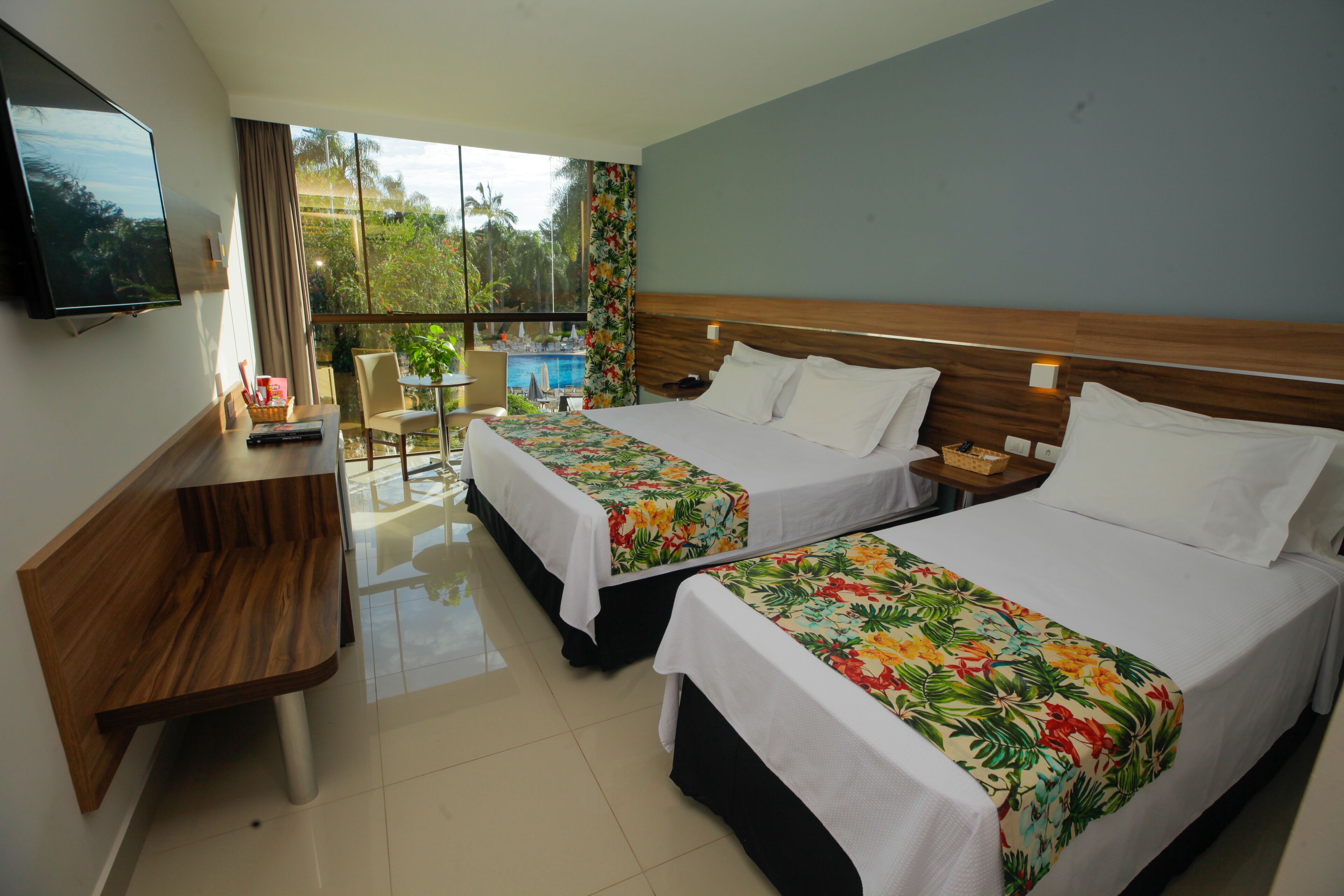 Deluxe Room, Pool View | Minibar, in-room safe, desk, laptop workspace