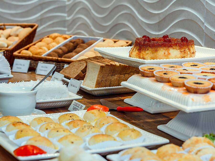 A buffet with various baked goods and desserts.