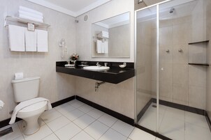 A modern bathroom with a toilet, sink, and shower.