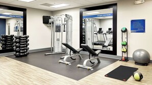 A gym with weight machines, dumbbells, exercise balls, and a mat. - Hampton Inn & Suites Ridgecrest (Ridgecrest)