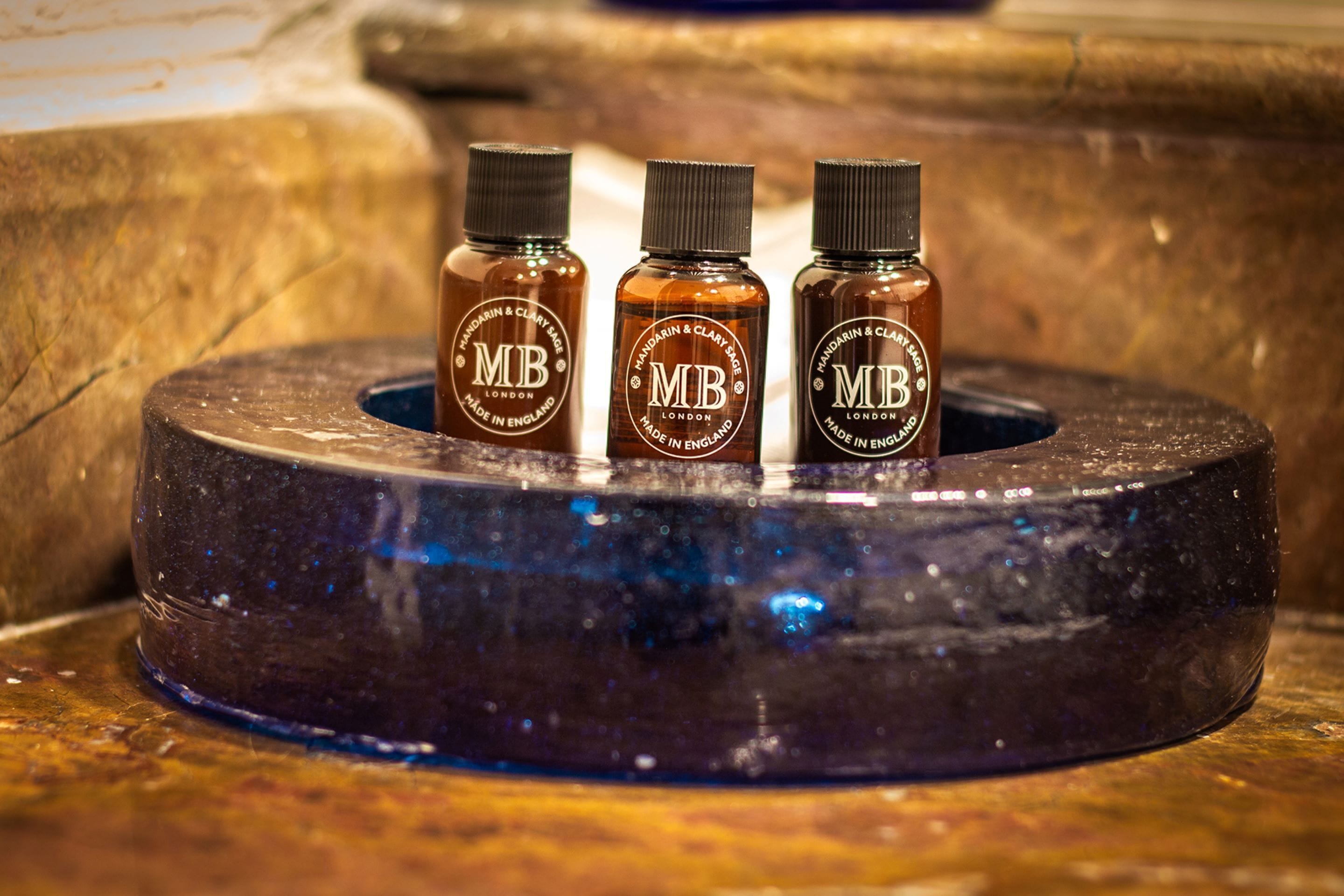 Three bottles of 'MB' on a circular object.