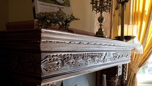 A fireplace with a decorative mantel, a framed picture above it, and a candelabra with candles. - Hotel Fidder - Patrick's Whiskybar (Zwolle)