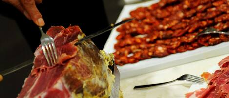 A person carving meat on a table.