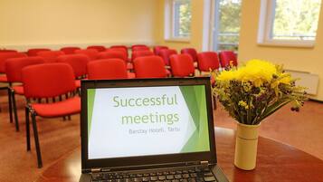 A laptop on a table displaying 'Successful meetings' at Barclay Hotel, Tartu.