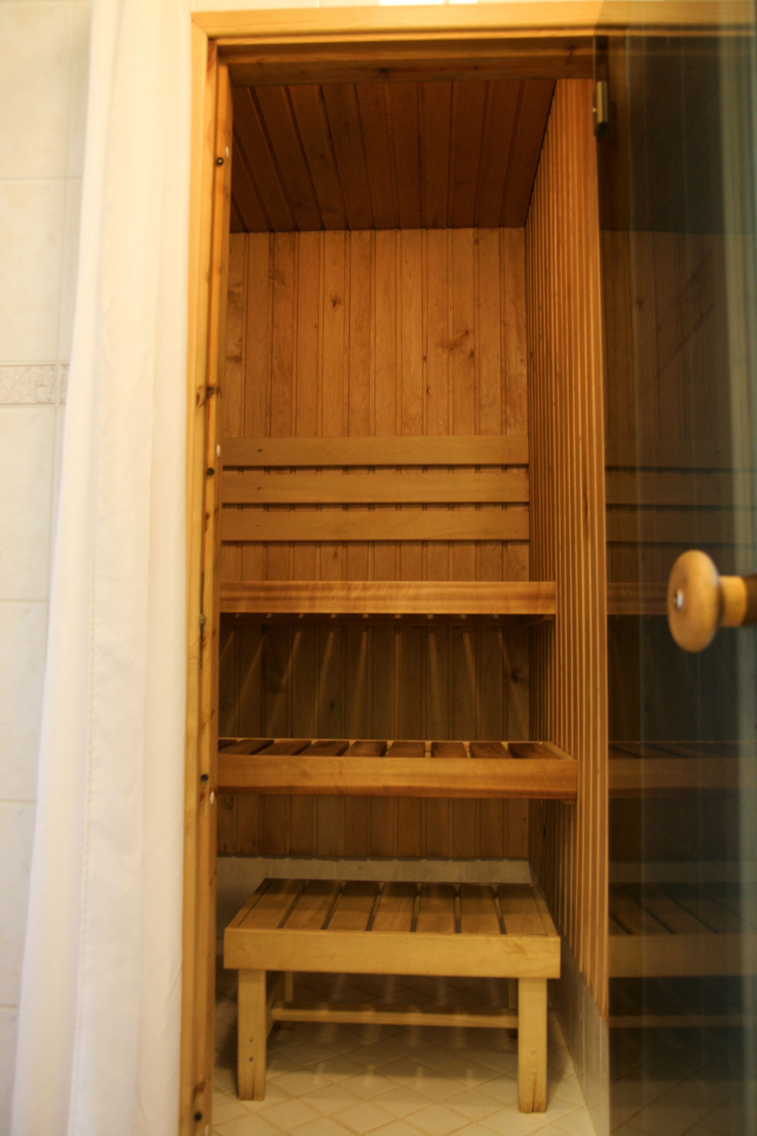 A wooden cabinet with shelves and a bench, likely used for storage or seating.
