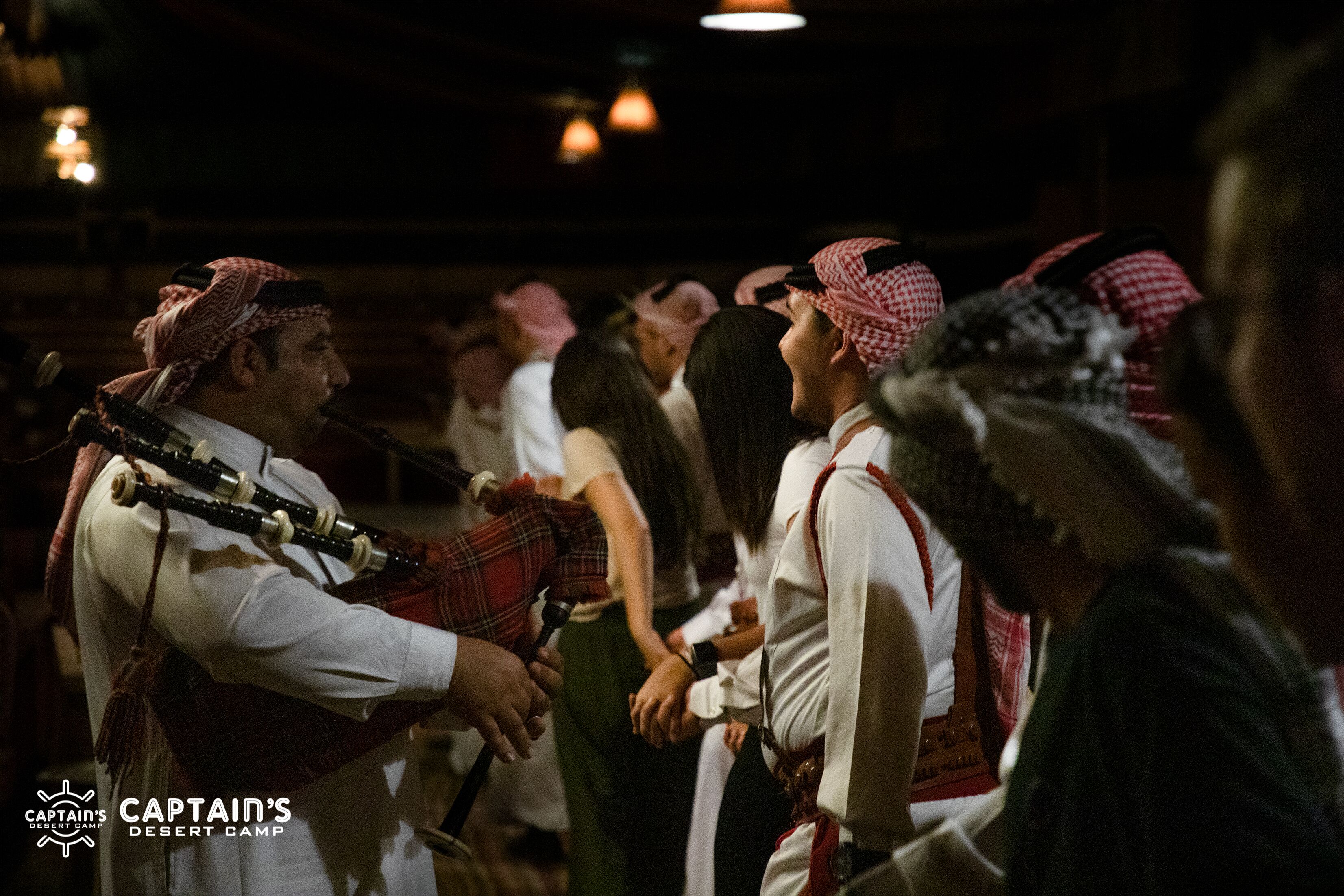A group of people in traditional attire, likely at a cultural event or celebration.