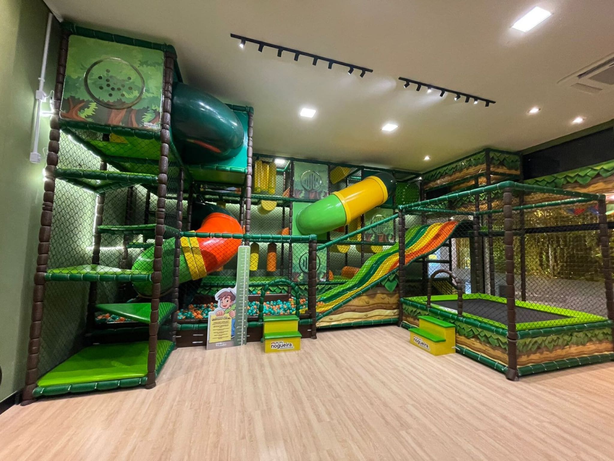 A play area with various climbing structures and slides.