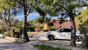 A white car parked in front of a building with a sign that reads "ENTREE La Bastide." - Hôtel Restaurant L'Etape (Bouc-Bel-Air)